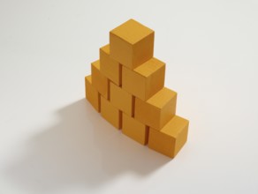 10 yellow wooden cubes against a white background