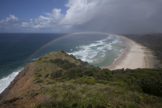 Tallow Beach bay with rainbow, lookout Byron Bay lighthouse, New South Wales, Australia