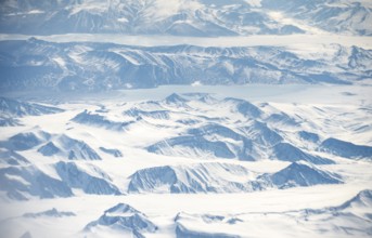 Icy, snowy arctic mountain landscape with glaciers, aerial view, Greenland, Arctic