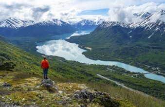 Climber enjoying the view, Slaughter Ridge Trail, view of snowy mountains and turquoise blue Kenai