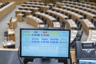 Plenary hall deserted with the seats of deputies and the government bank. Behind it is the
