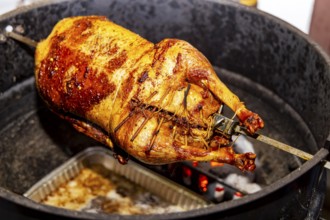 Christmas goose is grilled on a kettle grill. Münsingen, Baden-Württemberg, Germany