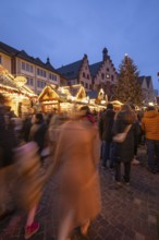 December 22, 2025, Frankfurt Christmas Market on Roemerberg at twilight. Traditional wooden stalls