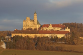 Benedictine monastery with late baroque monastery church, lighting atmosphere, winter, Neresheim,