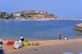 People, boats, Sant Feliu de Guixols beach on the Costa Brava, Spain, June 1999, vintage, retro,