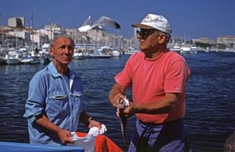 Fish seller, seagull in flight, fish market, Vieux Port, Marseille, southern France, June 1999,