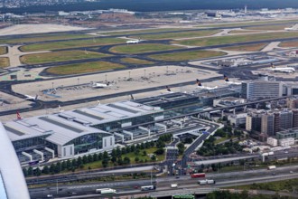 View of a large airport with several aircraft, runways and surrounding infrastructure, view of