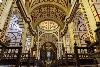 Sumptuous church interior with ornate ceilings and red patterns, The Basilica of St. Francis in