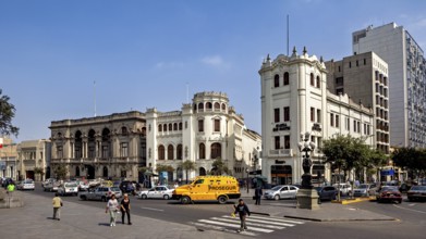 Distinctive historic buildings at a busy crossroads under blue skies, Downtown Lima in Peru