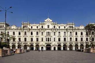 Large historic building in an open square with bright blue sky, Downtown Lima in Peru