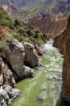 Green river flowing through a narrow gorge of rocks, The landscape of the Colca Canyon in the Andes