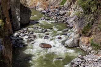 River with fast rapids flanked by rocks, The landscape of the Colca Canyon in the Andes of Peru