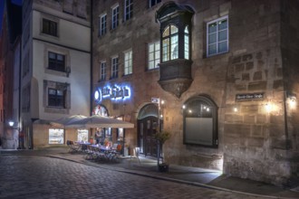 Historic restaurant, Alte Küch'n, with choirs in the evening lighting in the old town,