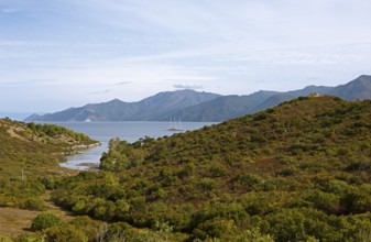 Sailing boat in the Mediterranean, Gulf of Saint-Florent, in front of the Agriates Desert or