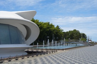 Futuristic building next to a fountain under a blue sky, left registry office, Batumi Boulevard,