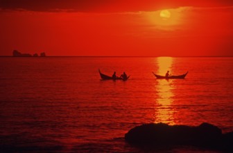 Fishing boats at sunset, silhouettes, orange filter, Ko Lanta island, Thailand, December 2002,