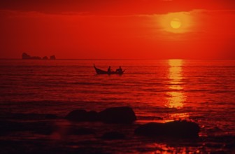 Fishing boat at sunset, silhouettes, orange filter, Ko Lanta island, Thailand, December 2002,