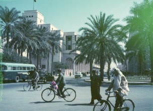 People cycling in city street, traffic in road passing Al Waddan Hotel, Sharia Sidi Issa, Tripoli,