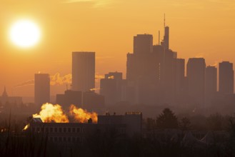 The sun rises behind Frankfurt's banking skyline, Frankfurt am Main, Hesse, Germany