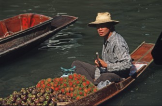 Merchant in his boat at Damnoen Saduak Floating Market, Thailand, December 2002, vintage, retro,