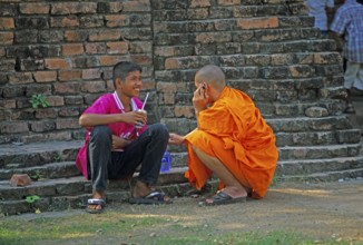 Monk talking on cell phone, teenager, Wat Phra Si Sanphet, Ayutthaya, Thailand, December 2002,