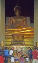 People praying in the temple with the Buddha statue Phra Mongkhonbophit, Ayutthaya, Thailand,