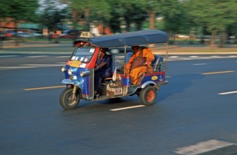 Monk in a three-wheeled tuk tuk taxi, blurred, Bangkok, Thailand, December 2002, vintage, retro,