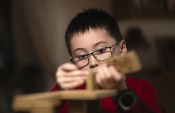 Boy, 6 years, glasses, multi-ethnic, plays concentrated, constructs, builds, Stuttgart,