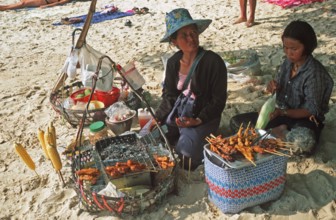 Woman and daughter with food stash on Pranang Cave beach, two years in front of the tsunami, Krabi,