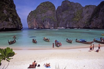 People, longtail boats on Maya Bay beach, known from the movie The Beach, one year in front of the