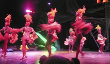 Revue dancers in opulent colorful costume and with feather headdress at Club Tropicana, Havana,