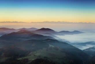 View from Belchen heading south of Wiesental and the Swiss Alps, morning atmosphere with fog in