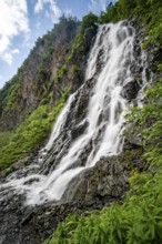 Horsetail Falls waterfall on the Lowe River in a green gorge, long exposure, Keystone Canyon,