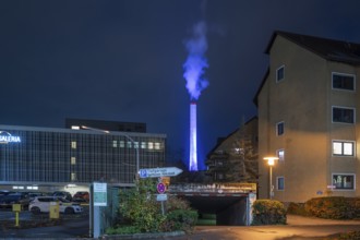 Glowing blue chimney from the CHP plant in the evening, Erlangen.Mittelfranken, Bavaria, Germany