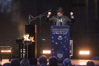 Yehuda Teichtal (Rabbi of the Chabad-Lubavitch movement) speaks at the lighting of lights to mark