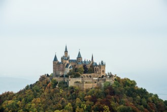 Castle and autumnal forest, Hohenzollern Castle, Hechingen, Swabian Jura, Baden-Württemberg,