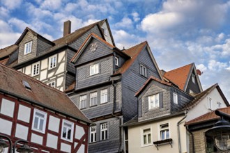 Traditional half-timbered houses with tiled roofs and cloudy skies, The historic city center of