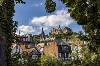 Picturesque view of Marburg's old town with historic half-timbered houses and a castle on a hill,