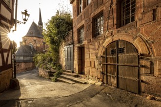 Romantic alleyway scene in the old town with sunlight, shadows and old architecture, The historic