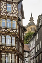 Combination of elaborate half-timbered details and Gothic church tower in the cityscape, The