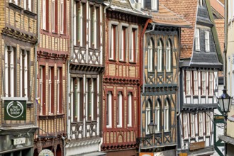 Detailed, colorful half-timbered facades in a cramped old town alleyway, The historic old town of
