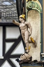 An ornate wooden statue in Roman style as building decoration, gilded details, historic and