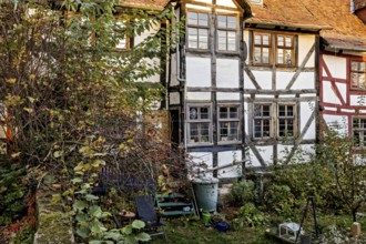 Idyllic garden with historic half-timbered house in autumn, the historic city center of Marburg in