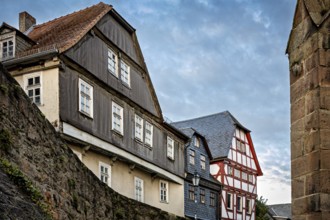 Historic buildings with tiled roofs along a city wall, The historic city center of Marburg in Hesse