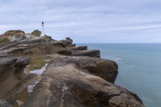 Castlepoint lighthouse on a rock, sea, long exposure. Castlepoint, Wairarapa Coast, Wellington