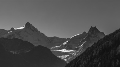 The snow-capped peaks of the Zinalrothorn and Besso mountains, black and white photo, Val