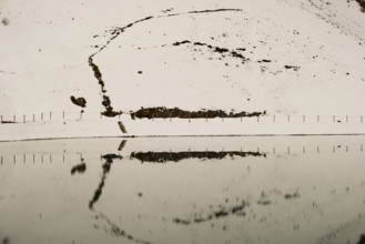 Another onset of winter in May, Riezler Alpsee, an artificially created lake, snow pond, feeds the