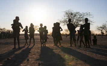Himba children playing, evening mood, traditional Himba village, Kaokoveld, Kunene, Namibia