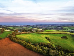 Sunset of Devon Farms and Fields over Berry Pomeroy from a drone, Totnes, England, United Kingdom