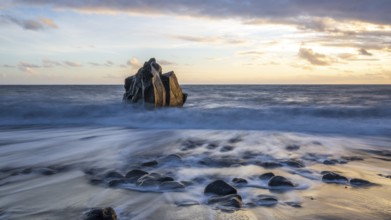 Sunset, waves and rocks in the sea, Praia Formosa, Madeira, Portugal